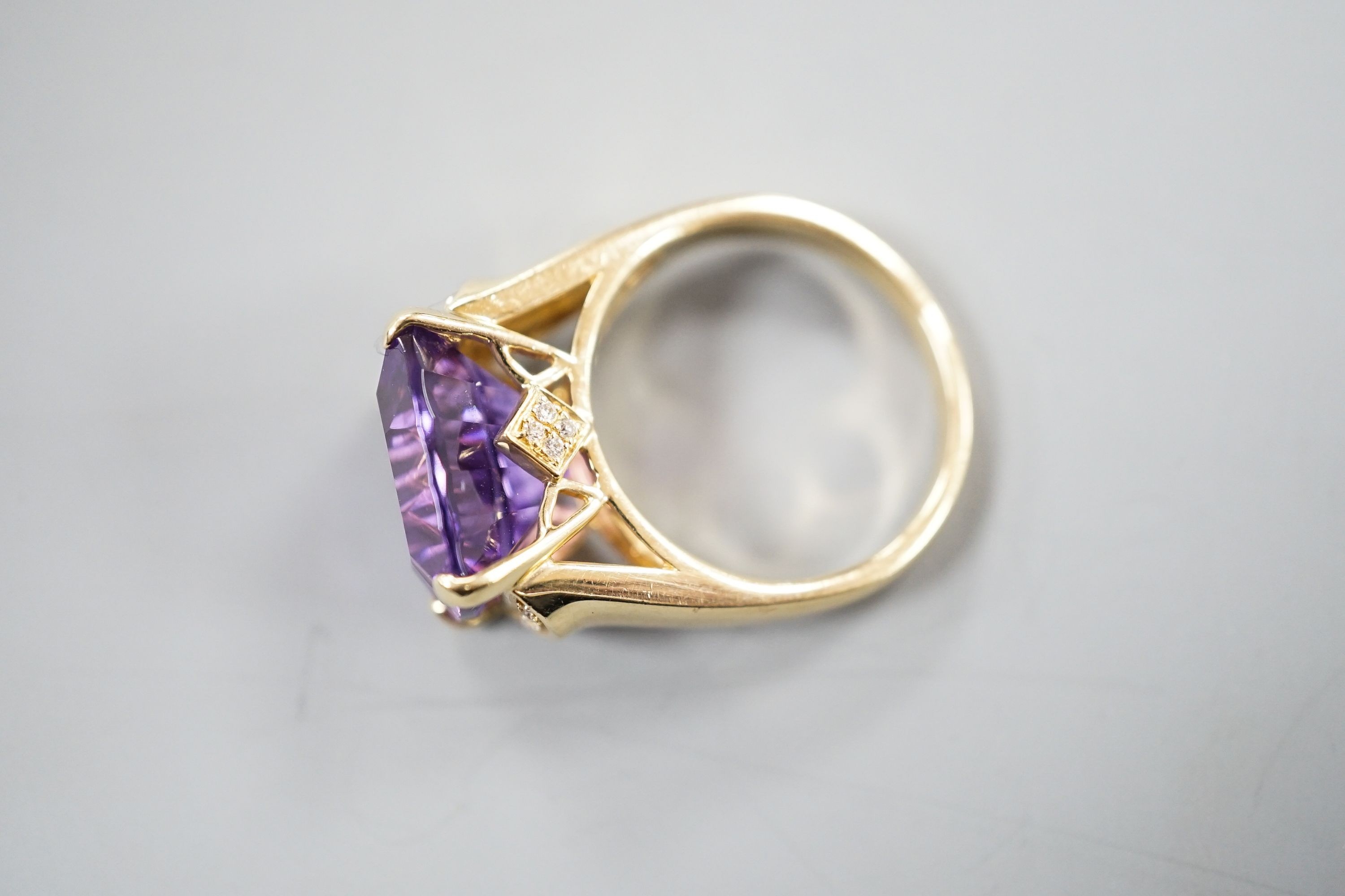 A modern 14k yellow metal, fancy cut amethyst and diamond chip set dress ring, size P/Q, gross weight 8 grams.